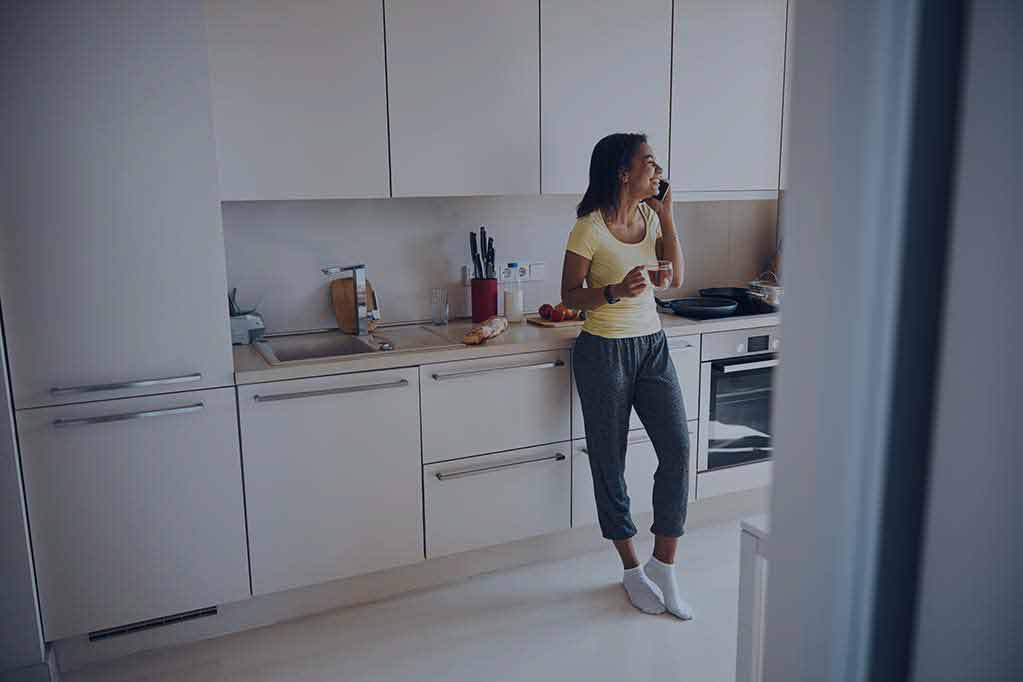 1cheerful-young-woman-talking-on-mobile-phone-at-ho-2024-10-18-08-38-28-utc