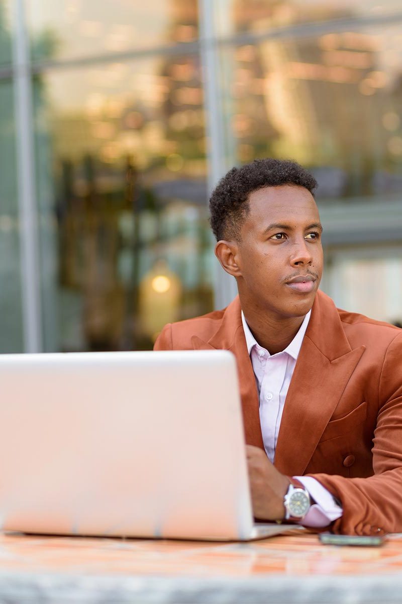 african-businessman-outdoors-in-coffee-shop-using-2026-01-07-06-45-07-utc