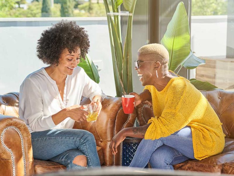 cheerful-diverse-women-having-fun-on-sofa-at-home-2025-04-04-02-12-36-utc