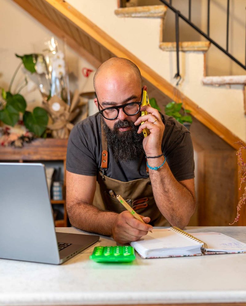 man-talking-on-phone-while-working-at-desk-2026-03-26-10-32-18-utc