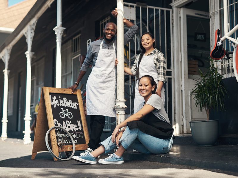 portrait-of-three-young-workers-sitting-outside-of-2026-01-09-09-37-32-utc